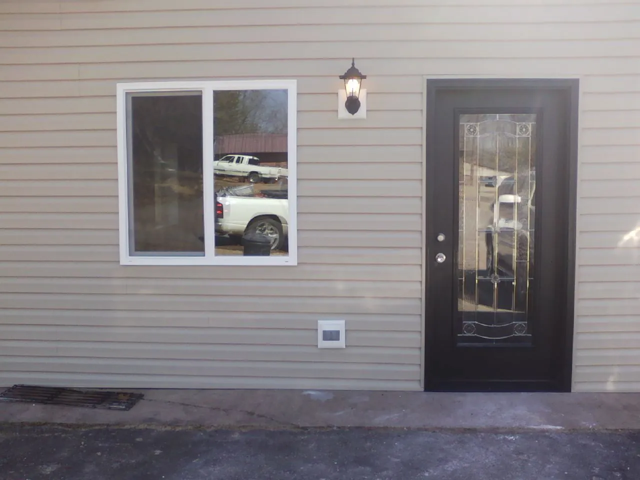 New siding, window and entry door on the side of an addition in Haverstraw