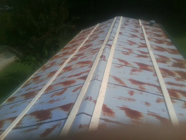 Rusted metal roof panels with new wood purlins before replacement — Storm Damage Roof Repair in Haverstraw by Roofing Brothers