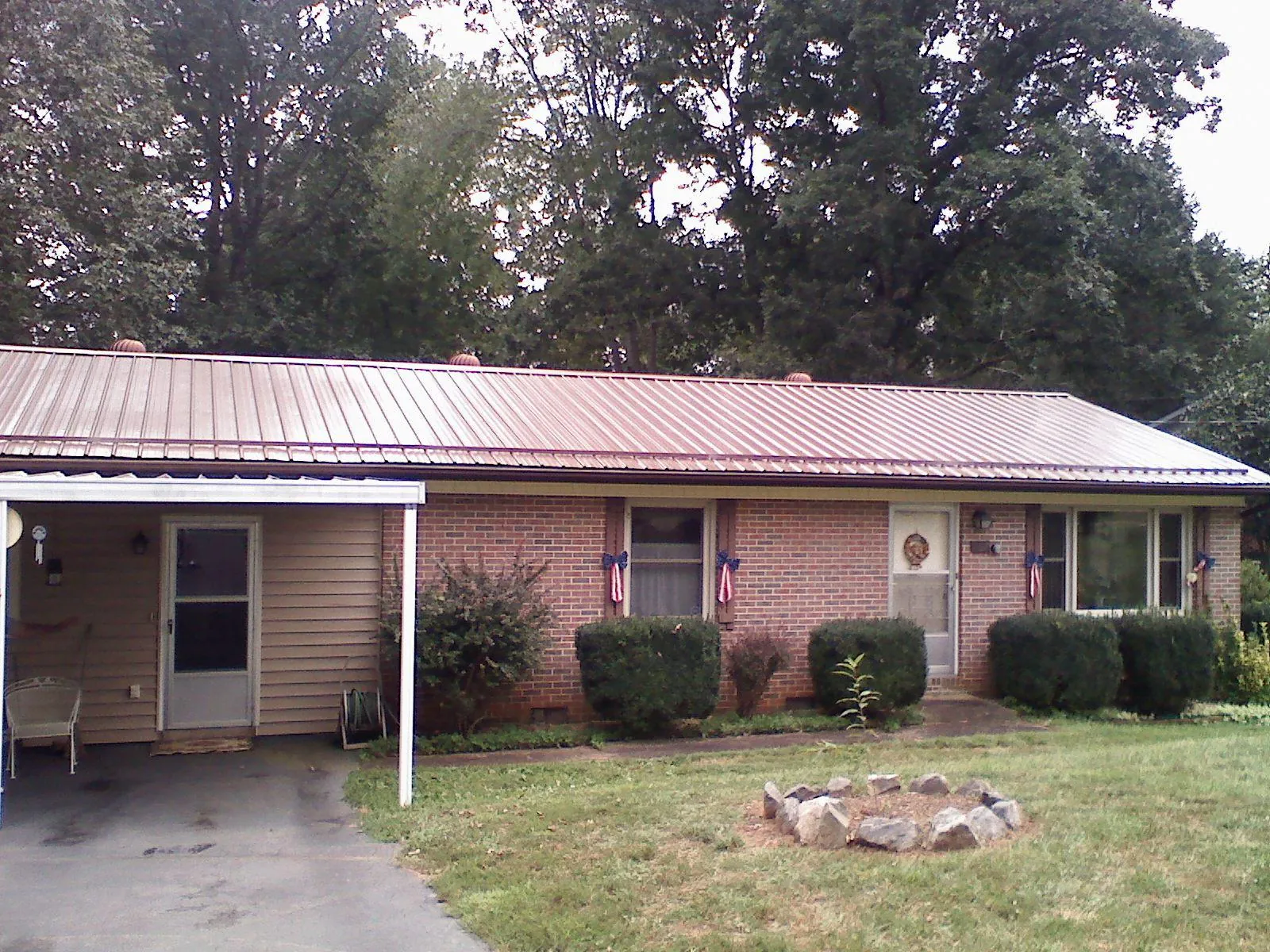 Bronze metal roof and carport on a brick ranch home — Roof Repair work by our crew in Haverstraw